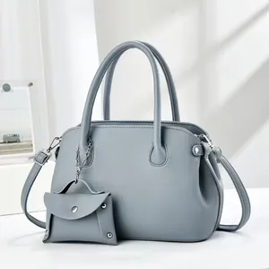 Detail of grey-blue lychee grain leather tote bag with a matching small coin purse attachment