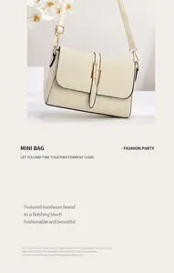 Detailed view of cream leather shoulder bag featuring gold metal hardware and lock closure