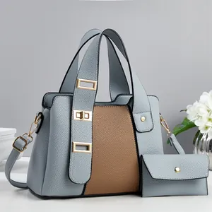 Detail of blue and brown litchi pattern leather handbag with golden hardware and coin purse
