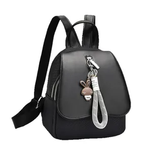 Versatile black minimalist backpack for women featuring a cute bunny charm and flap closure