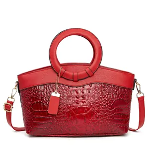 Elegant red crocodile textured handbag with lychee leather details and golden hardware