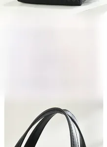 Gros plan sur le sac cabas en cuir tressé noir montrant les détails de la base et texture