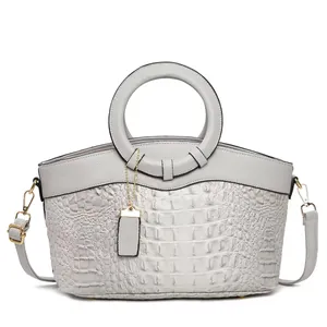 Light gray faux crocodile leather handbag with circular handles and gold hardware