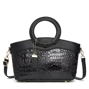 Elegant black crocodile texture handbag with circular metal handle and golden hardware