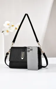 Detailed size comparison of a black lychee texture crossbody bag with a smartphone