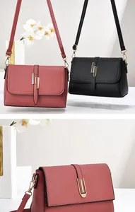Detailed view of lychee texture faux leather bag with gold geometric metal buckle