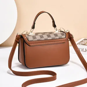 Elegant warm brown crossbody bag with monogram flap and top handle for women