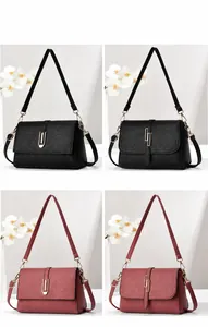 Detailed comparison of textured black and brown crossbody bags with gold hardware