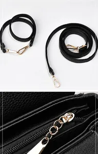 Detail of dual black lychee leather straps with gold metal hooks and zipper closure