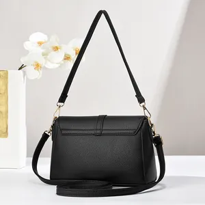 Close-up of black lychee texture leather surface with high-quality gold metal hardware