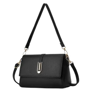 Minimalist black lychee texture shoulder bag with elegant golden U-shaped metal buckle