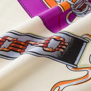 Macro shot of silk twill scarf fabric featuring equestrian strap and buckle patterns