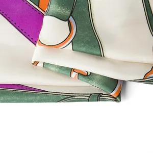 Detailed view of the twill silk texture and colorful belt chain pattern on the scarf