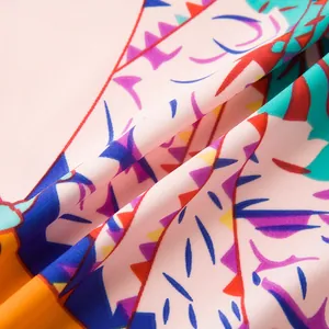 Close-up of vibrant twill fabric showing detailed silk-like texture and colorful patterns