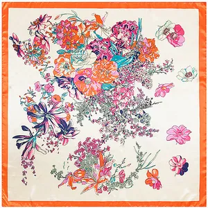 Detail view of the silk scarf featuring colorful floral patterns and orange hem borders