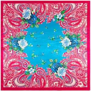 Flat lay of square silk scarf with paisley patterns and vibrant blue rose floral prints