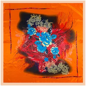 Detailed close-up of orange silk scarf with blue floral and golden paisley patterns