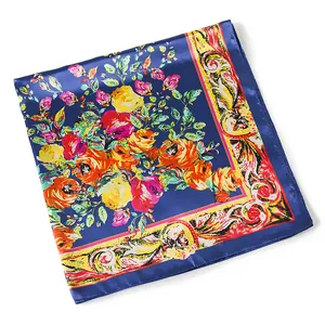 Macro view of blue silk scarf showing satin texture with vibrant rose floral patterns