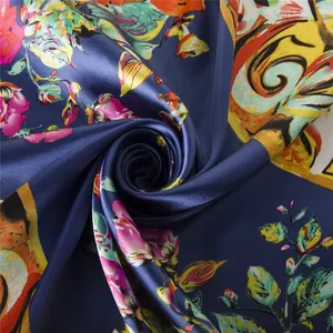 Macro detail of navy silk scarf with floral prints and pearlescent satin texture