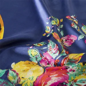 Detailed macro view of the silky blue fabric with yellow and pink floral patterns