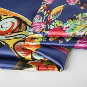 Detailed view of silk square scarf featuring vibrant floral prints and glossy texture