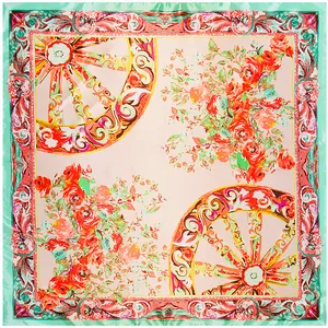 Detail of baroque silk scarf featuring floral patterns and golden carriage wheels