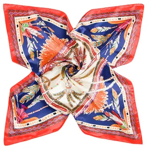 Detail of silk square scarf showing ethnic feather pattern and red borders in a spiral fold