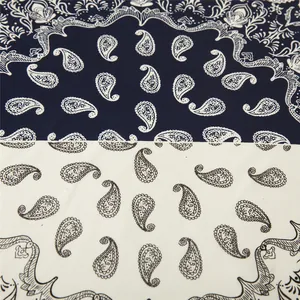 Macro view of navy and white paisley pattern on satin square scarf fabric texture