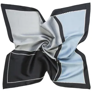 Macro detail of geometric color block silk scarf with satin luster and dotted border