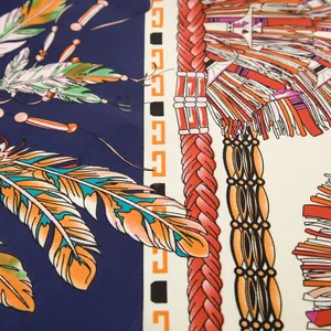 Macro detail of ethnic style silk scarf featuring vibrant feather patterns and rich textures