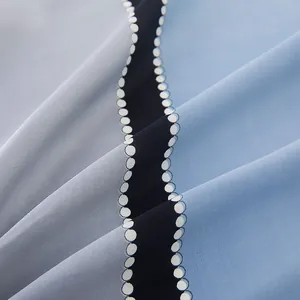 Detailed view of the gradient chiffon fabric with smooth texture and wavy dot patterns