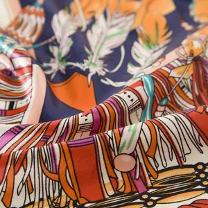 Detailed macro view of silk scarf fabric showing feather patterns and glossy texture