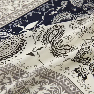 Macro shot of paisley pattern and texture on satin silk scarf in navy and beige