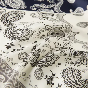 Close-up of paisley pattern on a silky 60cm navy blue and white satin square scarf