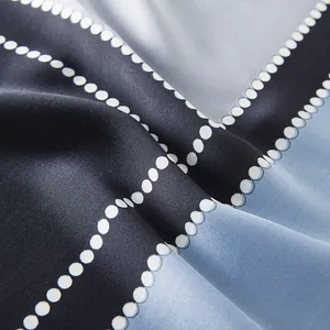 Detailed close-up of smooth silk scarf fabric with blue and black geometric color blocking