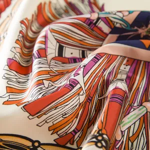 Macro detail of twill silk scarf showing intricate feather pattern and vibrant colors