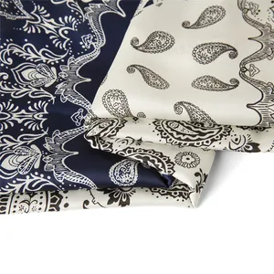 Macro view showing detailed paisley patterns on navy and white satin square scarves