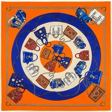 Flat lay detail of a square silk scarf featuring handbag prints and gold chain motifs