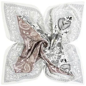 Macro detail of satin paisley square scarf with boho floral patterns in coffee and white