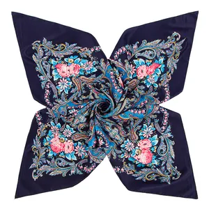 Macro detail of navy silk scarf featuring paisley patterns and pink rose floral prints