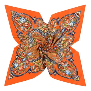 Macro shot of 100cm bohemian silk scarf with orange paisley and floral pattern