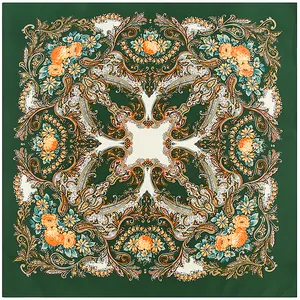 Flat lay view of a dark green square scarf with intricate orange paisley floral patterns