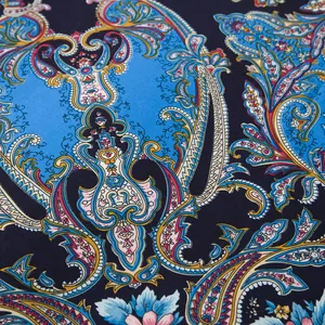 Detail of navy blue silk scarf featuring vibrant paisley and rose floral patterns