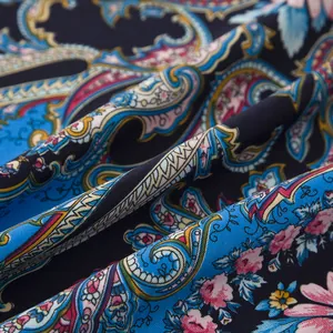 Detail of paisley and rose pattern on silky ethnic scarf with deep blue highlights