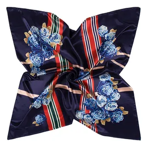 Dettaglio del motivo a rose e trama satinata su un foulard di seta blu navy elegante