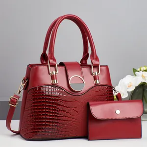 Dark red tote bag set with crocodile texture, gold ring lock, and matching clutch bag