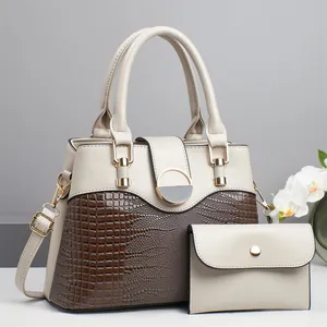 Two-piece handbag set featuring beige and brown croc texture with a round gold buckle
