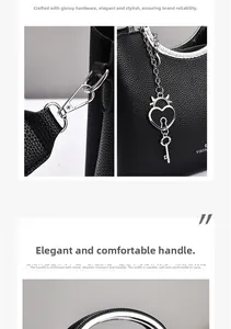Macro detail of silver metal handles and lychee textured leather on black fashion handbag