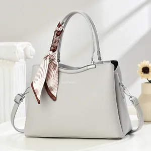Light grey pebble leather handbag with silk scarf detail and adjustable shoulder strap