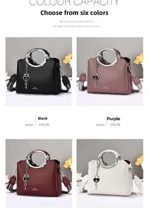 Close-up of litchi grain leather handbags with ring handles and heart key charms